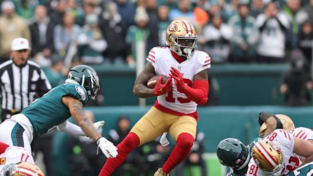 49ers wide receiver Deebo Samuel runs through Eagles defenders.